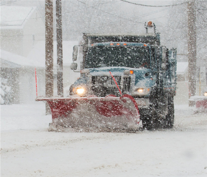 Snow plow on snowy road